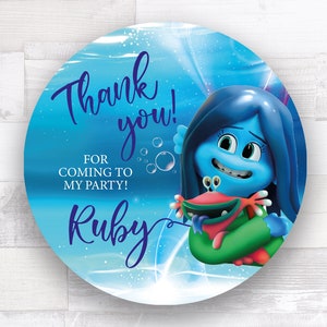 May include: Blue and green thank you sticker with a blue character holding a red crab. The sticker says "Thank you! For coming to my party! Ruby"