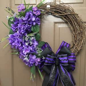 Purple and black floral grapevine wreath with greenery and ribbon