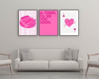 May include: Three framed prints in pink and white with a stadium, text that says "A-Town, I'll see you soon." and a playing card with a heart and the text "Lucky me I'm a Bubcat".