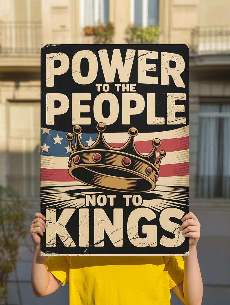 May include: A rectangular sign with the text "POWER TO THE PEOPLE NOT TO KINGS" in a distressed font. The sign features an American flag design and a gold crown illustration. The sign is held by a person wearing a yellow shirt.