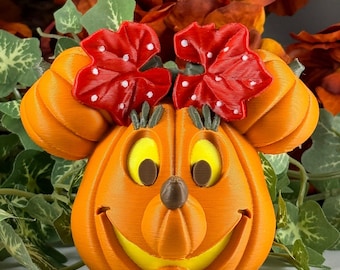 May include: Orange pumpkin with a Mickey Mouse face carved into it. The pumpkin has red bows with white polka dots on top.