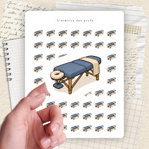 May include: A sheet of stickers featuring a massage table design, with a large table and many smaller versions. The table has a blue surface, a beige towel, and a wooden frame. The text "L'armoire des profs" is at the top.