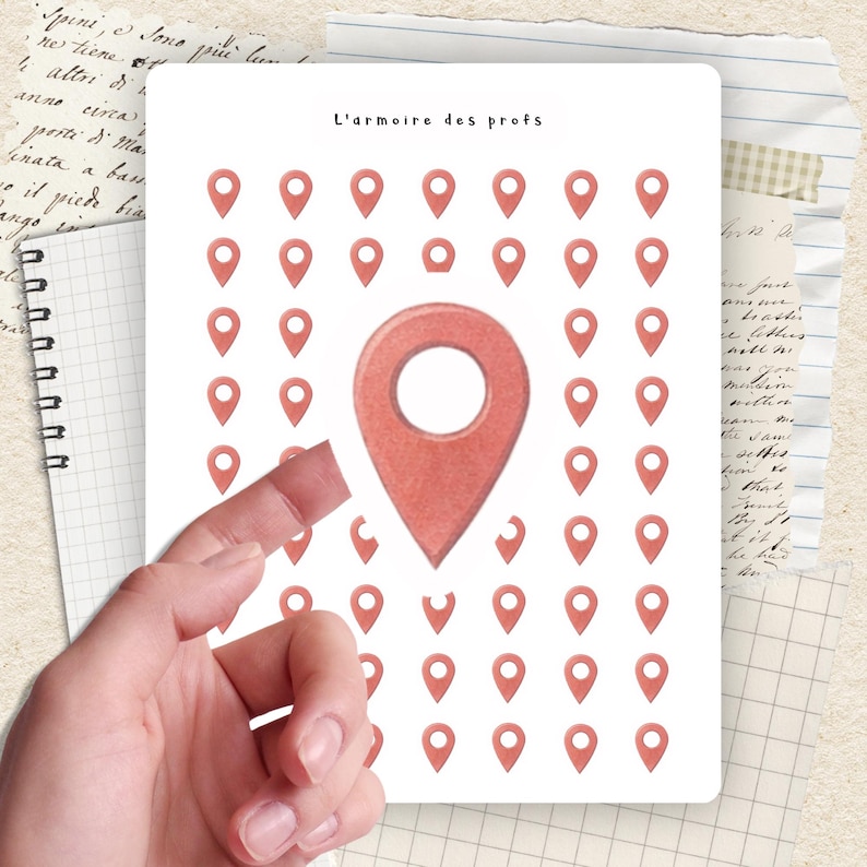 May include: A white card with the text "L'armoire des profs" and a grid of red location pin icons. A hand is holding the card. The background includes notebook paper and vintage paper.