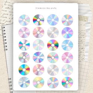 May include: A sticker sheet featuring twenty-four circular holographic CD designs arranged in a grid. Each disc displays a unique iridescent rainbow light reflection on its surface. The text L'armoire des profs is printed in black at the top centre.