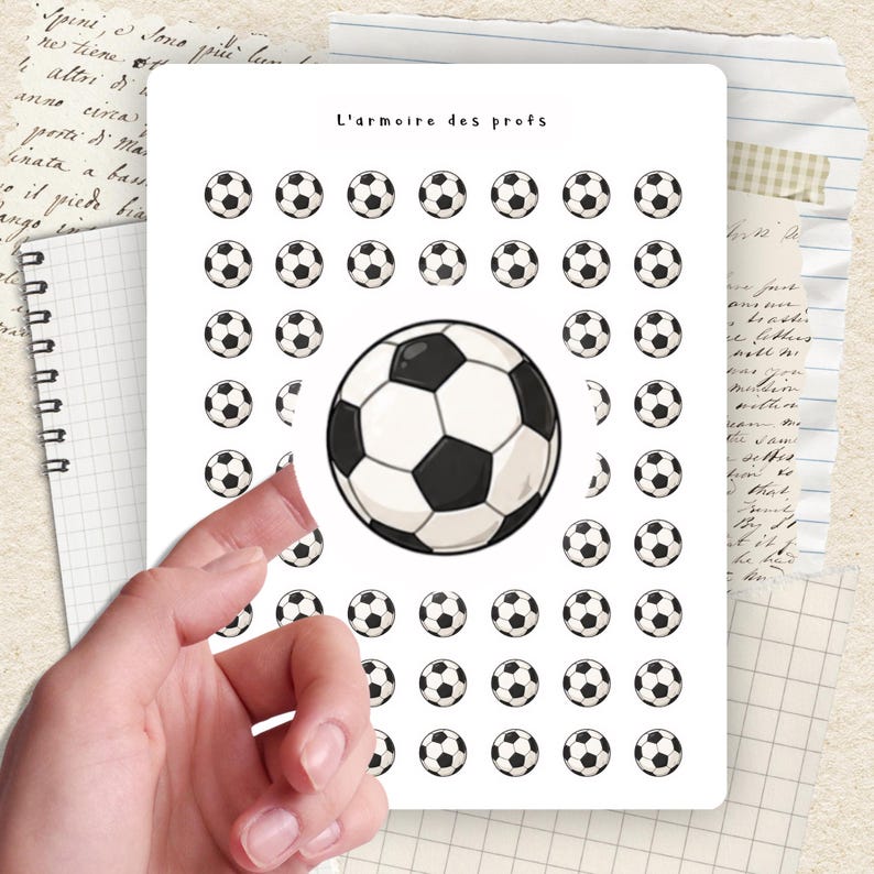 May include: A sheet of stickers featuring soccer balls. The stickers are white with black pentagons. The text "L'armoire des profs" is at the top. The sheet is on a background of lined paper and handwritten notes.