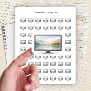 May include: A sheet of stickers featuring a large monitor with a landscape scene, surrounded by smaller monitor stickers. The text "L'armoire des profs" is at the top. A hand is peeling back a corner of the sticker sheet.