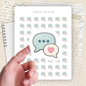 May include: A sheet of stickers featuring speech bubbles with hearts. The stickers are in shades of blue and pink, with the text "L'armoire des profs" at the top. The sheet is held by a hand, with a notebook and other papers in the background.