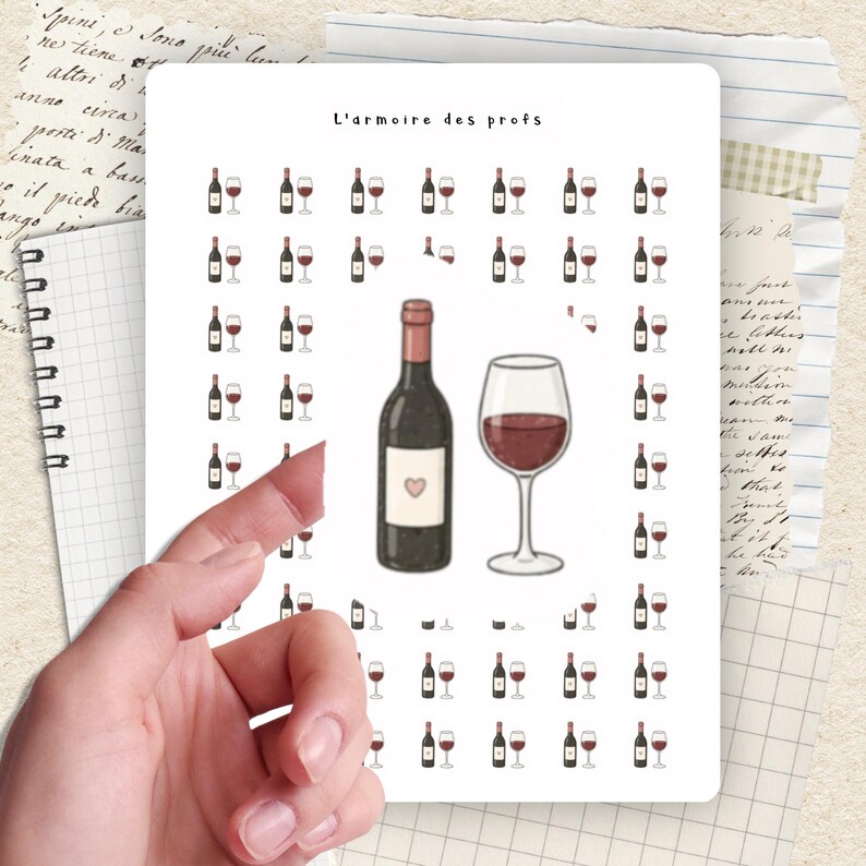 May include: A white sticker sheet featuring wine-themed illustrations. The sheet includes a wine bottle with a heart label, a wine glass, and multiple smaller wine bottle and glass pairings. The text "L'armoire des profs" is at the top.