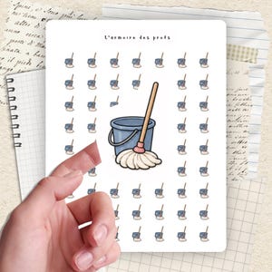 May include: A sheet of stickers featuring a blue bucket with a mop and the text "L'armoire des profs". The stickers have a white background and are surrounded by a hand.