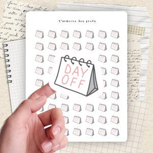 May include: A white sticker sheet featuring a repeating pattern of small calendar illustrations. A larger calendar sticker with the text "DAY OFF" in pink is held in a hand. The text "L'armoire des profs" is at the top.