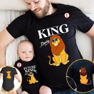May include: Black t-shirts with a lion graphic. One shirt says "KING Daddy" with a lion wearing sunglasses. The other says "FUTURE KING" with a lion cub. A matching baby bodysuit is also shown.