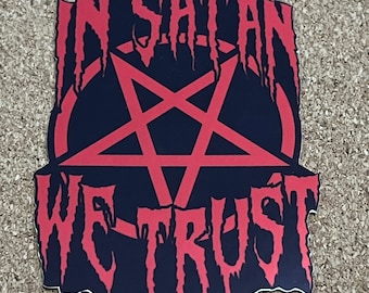 May include: Red and black sticker with a pentagram and the text "In Satan We Trust".