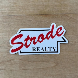 May include: White sticker with black border and red text that reads "Strode Realty".