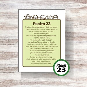 Op de afbeelding: Een groene en bruine printbare kaart met de tekst "Psalm 23" en een vers uit de Bijbel. Het vers is gedrukt in zwarte tekst op een lichtgroene achtergrond. De kaart heeft een rand van groene bladeren en een bruine cirkel met het nummer "23" in witte tekst.