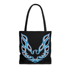 May include: Black tote bag with a blue and pink phoenix logo. The logo is a stylized bird with wings spread wide.