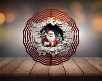 May include: A red metal wind spinner with a circular design. The center of the spinner features a graphic of Santa Claus breaking through a brick wall. The graphic is surrounded by a white brick wall with a blue sky and snow in the background.
