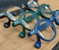 Set of 3 reading glasses, matte black, blue and green. +1 +1.5 +2 +2.5 +3 +3.5.  Round lenses with flex springs. 1 model, 3 different colors product logo