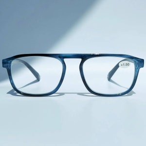 May include: Blue reading glasses with a +1.50 magnification. The glasses have a rectangular frame with a slight curve.