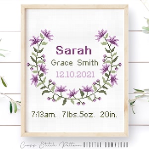 May include: Cross stitch pattern with a floral wreath, the name "Sarah Grace Smith", the date "12.10.2021", and the time and weight "7:13am. 7 lbs. 5oz. 20in."