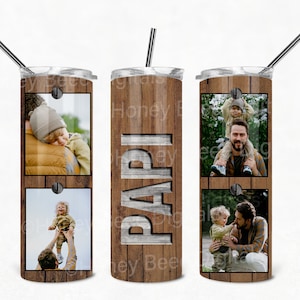 May include: A stainless steel tumbler with a wood grain design and three photos of a father and son. The tumbler has the word "PAPI" written on it in a wood grain font.