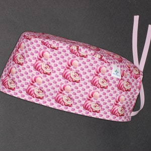 Pink Cheshire Cat surgical cap with straps for doctors, nurses, dentists