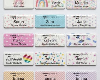 May include: A collection of fifteen rectangular name badges featuring the text hello my name is, individual names, and job titles. Each badge displays unique patterns including rainbows, hearts, polka dots, footprints, and chevron designs in various colours.