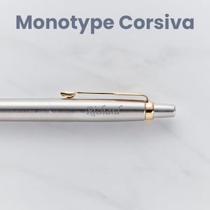 May include: A silver pen with a gold clip and a gold band near the tip. The pen is engraved with the name "Richard".