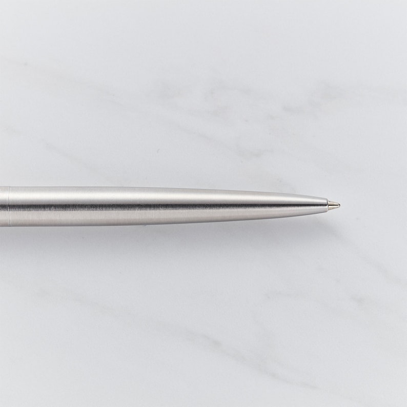 May include: A silver ballpoint pen with a brushed finish.
