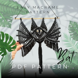 May include: Black macrame bat wall hanging with a wooden dowel and a long tassel. The pattern is called "Easy Macrame Pattern" and "PDF Pattern" is written below the bat. The image is set against a white background with green leaves.