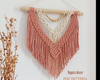 May include: A macrame wall hanging with a wooden dowel and beige and peach colored yarn. The wall hanging has a geometric pattern and wooden beads. The text "Nagara decor PDF PATTERN" is at the bottom of the image.