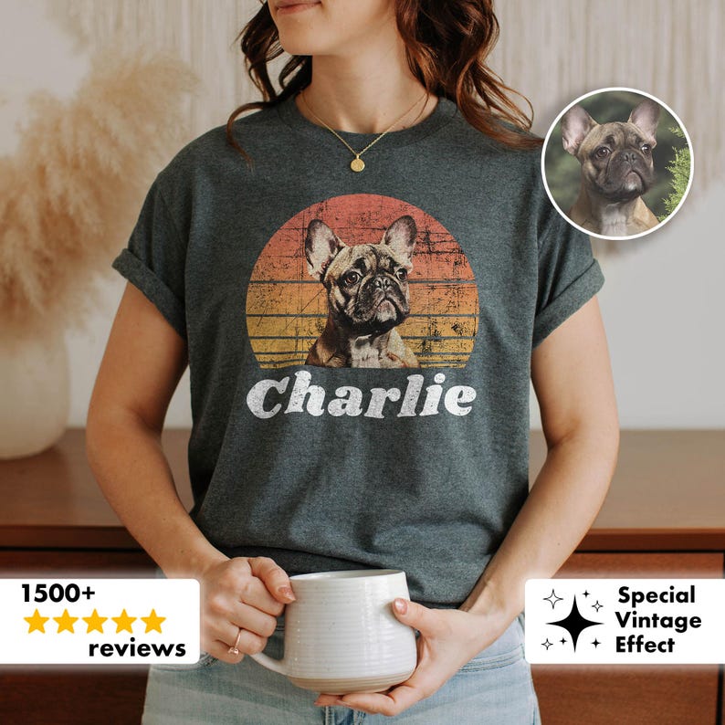 May include: Dark gray t-shirt featuring a French Bulldog graphic within a sunset-style circle. The dog's name, "Charlie," is printed in white below the image. The shirt has short sleeves.