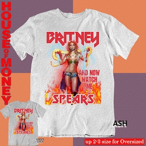 May include: Ash-colored t-shirt featuring a graphic of Britney Spears with the text "BRITNEY" in red, and "AND NOW WATCH ME SPEARS". A smaller version of the design is shown below. The shirt is labeled "SPORT GREY" and "up 2-3 size for Oversized".