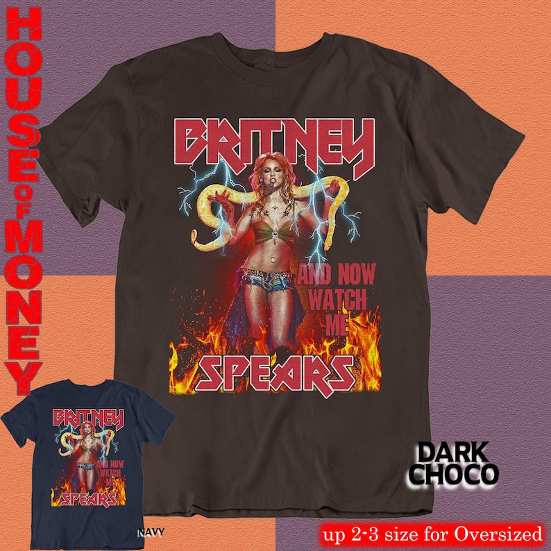 May include: Dark chocolate brown t-shirt featuring a graphic of Britney Spears with the text "BRITNEY SPEARS" in red. The design includes lightning bolts and flames. A navy blue t-shirt with the same design is also shown.