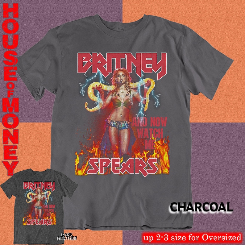 May include: Charcoal gray t-shirt featuring a graphic of Britney Spears with the text "BRITNEY SPEARS" in red. The design includes a lightning bolt and flames. The shirt is dark heather and available in up to 2-3 sizes for an oversized fit.