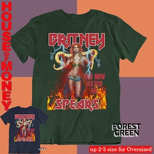 May include: Forest green t-shirt featuring a graphic of Britney Spears with the text "BRITNEY SPEARS" in red. The design includes lightning bolts and flames. A navy blue t-shirt with the same design is also shown.