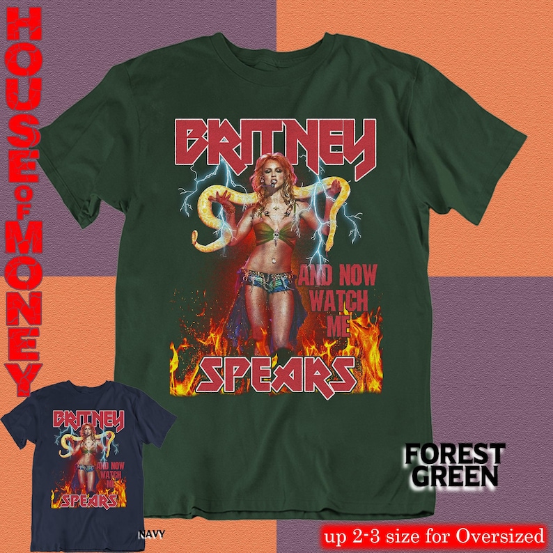 May include: Forest green t-shirt featuring a graphic of Britney Spears with the text "BRITNEY SPEARS" in red. The design includes lightning bolts and flames. A navy blue t-shirt with the same design is also shown.