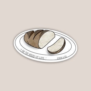 May include: A sticker featuring a loaf of bread with a slice cut out, presented on a white plate. The bread is brown with a light beige interior. The text "I AM THE BREAD OF LIFE." JOHN 6:35 is printed around the plate.