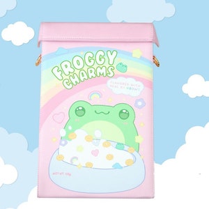 May include: A pink and green froggy charms themed bag with a rainbow and the text "FROGGY CHARMS" and "FLAVORED WITH REAL RAINBOWS!"