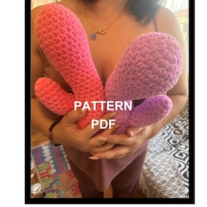 May include: Two crocheted finger puppets, one pink and one purple, held in a person's hands. The text "PATTERN PDF" is visible in the image.
