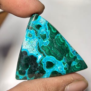 May include: A white ceramic mug with a black handle and the text "But First, Coffee" in a black, bold font. The mug is on a white surface.