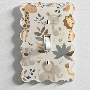 May include: A white light switch cover with a whimsical jungle animal design. The cover features a giraffe, lion, elephant, and monkey in a leafy pattern.