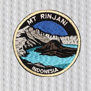 Op de afbeelding: Geborduurde ronde patch met Mt. Rinjani in Indonesië. De patch heeft een zwarte rand met gouden afwerking. Het ontwerp toont een blauwe lucht, een meer en een bergketen. De tekst "MT. RINJANI" en "INDONESIA" zijn opgenomen.
