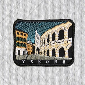 May include: A rectangular embroidered patch featuring a scene of Verona, Italy. The design includes a yellow building with green shutters next to a beige stone amphitheatre against a blue sky. The word VERONA is stitched in white at the bottom.
