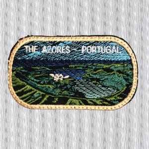 May include: Embroidered patch featuring a landscape scene with the text "THE AZORES - PORTUGAL" in white. The patch has a gold border and depicts a coastal view with blue, green, and black colors.