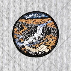 May include: A circular embroidered patch featuring a landscape of Thingvellir, Iceland, with a waterfall cascading over dark rocky cliffs into a blue stream, surrounded by tan terrain. The text PINGVELLIR is at the top and ICELAND is at the bottom.