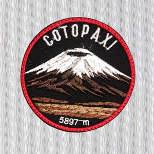 May include: Embroidered patch featuring the Cotopaxi volcano. The patch is circular with a black background and a red border. The volcano is depicted with white, brown, and black details, and the text "COTOPAXI" and "5897 m" are included.
