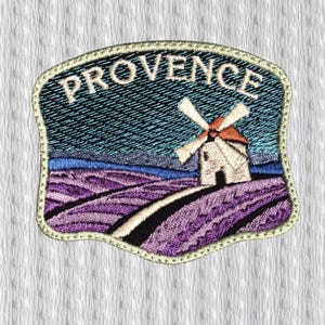 May include: Embroidered patch depicting a Provence landscape. It shows a windmill, lavender fields, and the word "PROVENCE" in white against a blue and black sky. The patch has a decorative border.