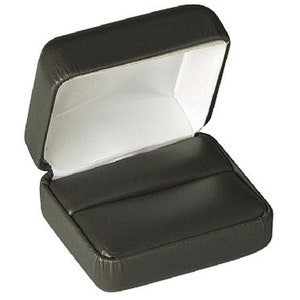 May include: A black leather ring box with a white interior and two compartments for rings.
