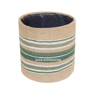 May include: Cylindrical woven basket with horizontal stripes in beige, green, and white. The interior is lined with black plastic. The text "MOHIL INTERNATIONAL" is printed on the side.