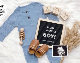 May include: A blue baby onesie with brown booties, a wooden rattle, and a letter board that reads "We're having a boy! Baby Williams". There is also a black and white ultrasound image and a bouquet of dried pampas grass.